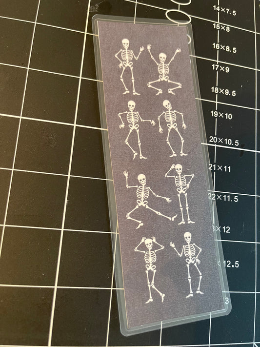 Dancing skeletons — laminated bookmark